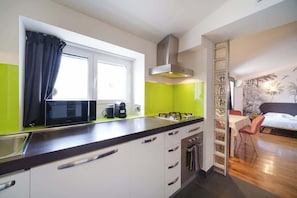 A modern kitchen with a window, a microwave, a coffee maker, and a sink.
