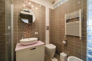 A bathroom with a sink, toilet, and shower.