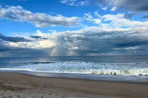 A beach with waves, a rainbow, and a cloudy sky. - Lake, Love, and the Sand (Hilton Head Island)
