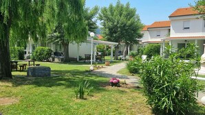 Une cour dotée d’une pergola, d’un espace salon extérieur et d’un jardin.