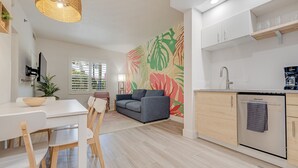 A modern kitchen with white cabinetry, a built-in oven, and a coffee machine. - Near Epic Universe & Universal, +parking & Netflix (Orlando)