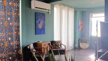 Comfort Apartment, Beach View | Living area | 40-inch flat-screen TV with digital channels