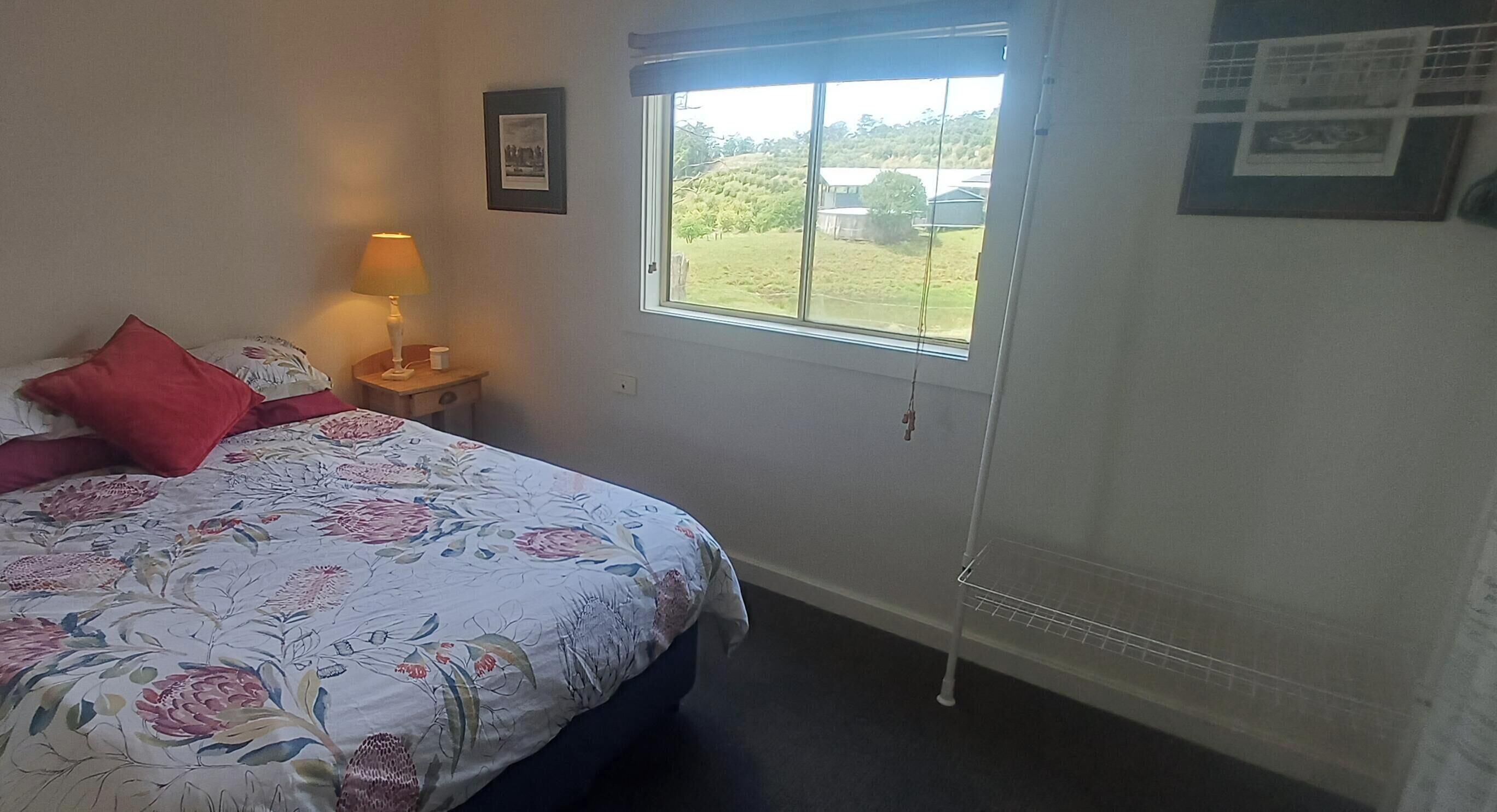 Bedroom 1 - double bed with cupboard, hanging spaces, bedside table and light