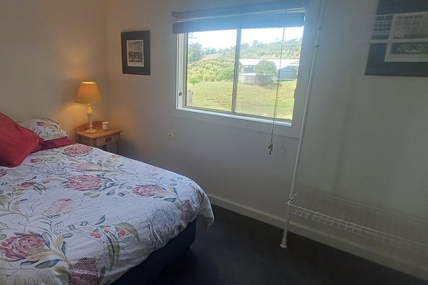 Bedroom 1 - double bed with cupboard, hanging spaces, bedside table and light