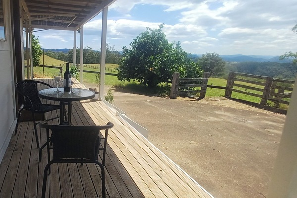 Cottage verandah with pasture and mountain views