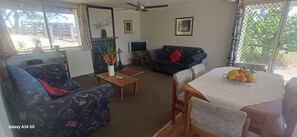 Fireplace, books - The Old Dairy Cottage - rural retreat with mountain and bush panorama (Innes View)