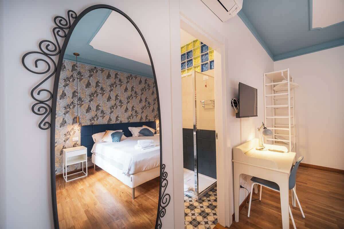 Ein Schlafzimmer mit Bett, Schreibtisch und Dusche.