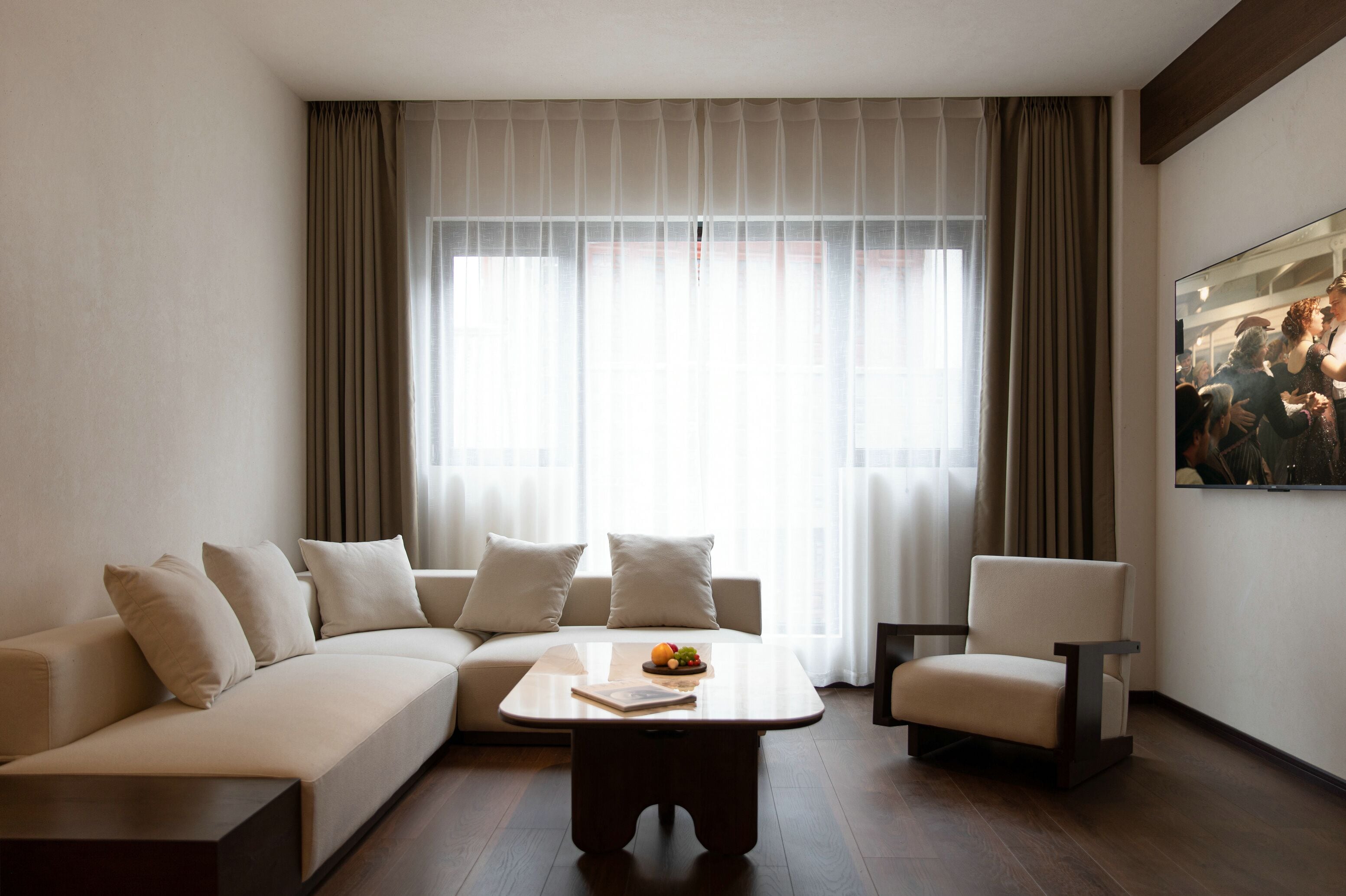 A modern living room with a sofa, armchair, and coffee table.