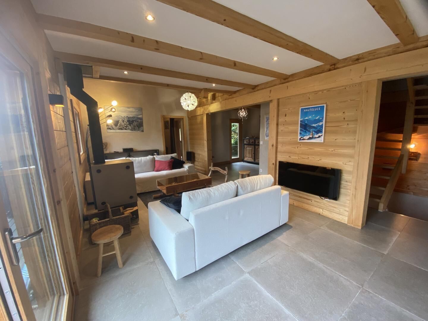 A spacious living area with a fireplace, a sofa, and a dining table.