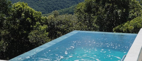 Deluxe Chalet, Lanai, Valley View | Infinity pool | Outdoor pool, pool umbrellas, sun loungers