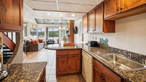 A kitchen with wooden cabinets, granite countertops, and a stainless steel sink. - Beaver Run 28220: Ski-In/Out Peak 9 Condo, Fireplace, Pools & Hot Tubs. (Breckenridge)