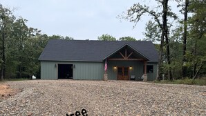 A building with a gravel driveway and a wooden deck.