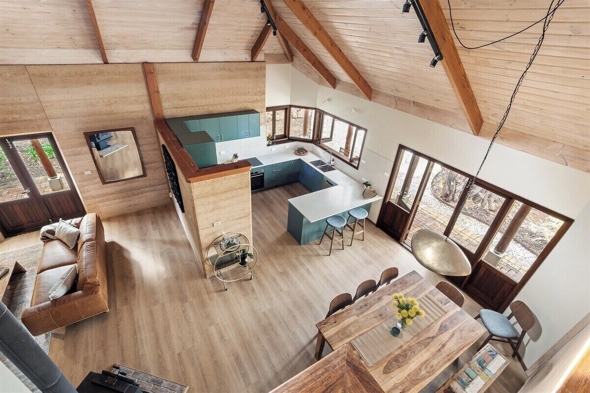 A modern interior with a kitchen, dining area, and seating space.