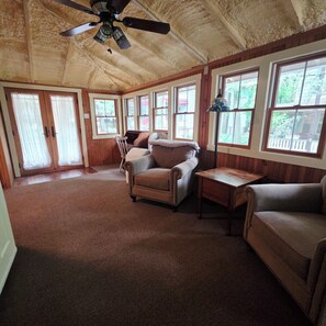 A room with a ceiling fan, large windows, and a brown carpet. - Family Lake Days - Walk to Beach, Shows, Ice Cream (Mount Gretna)