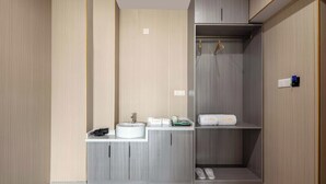 A modern bathroom with a built-in sink, vanity, and a walk-in shower. - Wonderful Beginning (Tai'an)