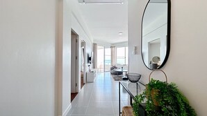 A modern hotel hallway with a glass railing, a large mirror, and a potted plant. - Seaview 2beds in the heart of HuaHin BP2 (Hua Hin)