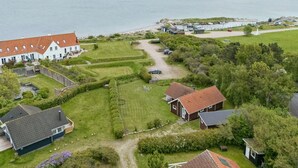 A coastal residential area with houses, a grassy field, and a view of the sea. - "Terne" - 90m from the sea by Interhome (Nykøbing Sj)
