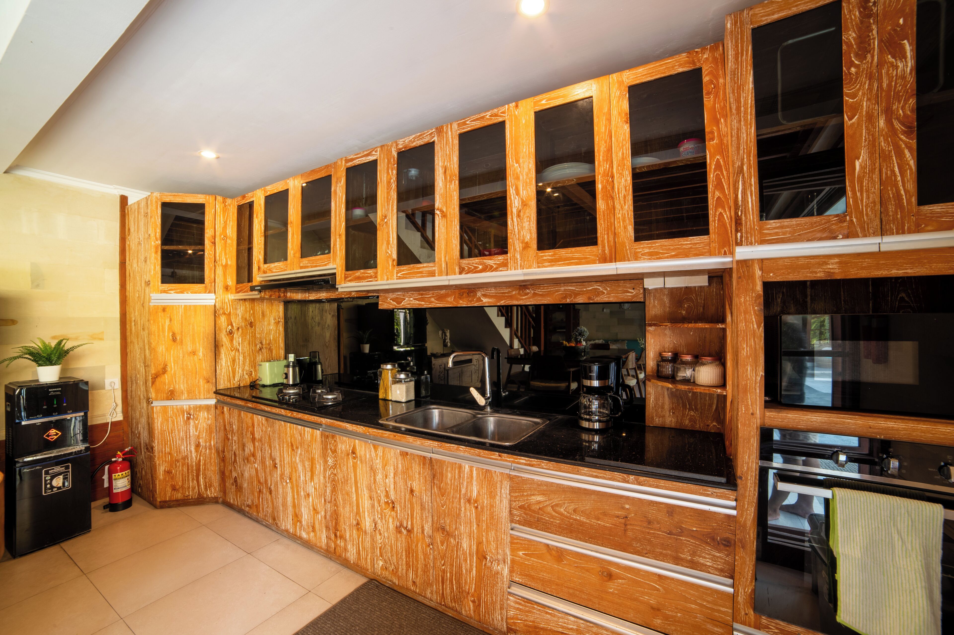 A kitchen with wooden cabinets, a black countertop, and stainless steel appliances.