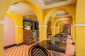 A hotel dining area with a long table, chairs, and a patterned floor. - Kastel Bangkok Hotel (Bangkok)