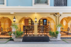 A hotel lobby with arched ceilings, a reception desk, and seating areas. - Kastel Bangkok Hotel (Bangkok)