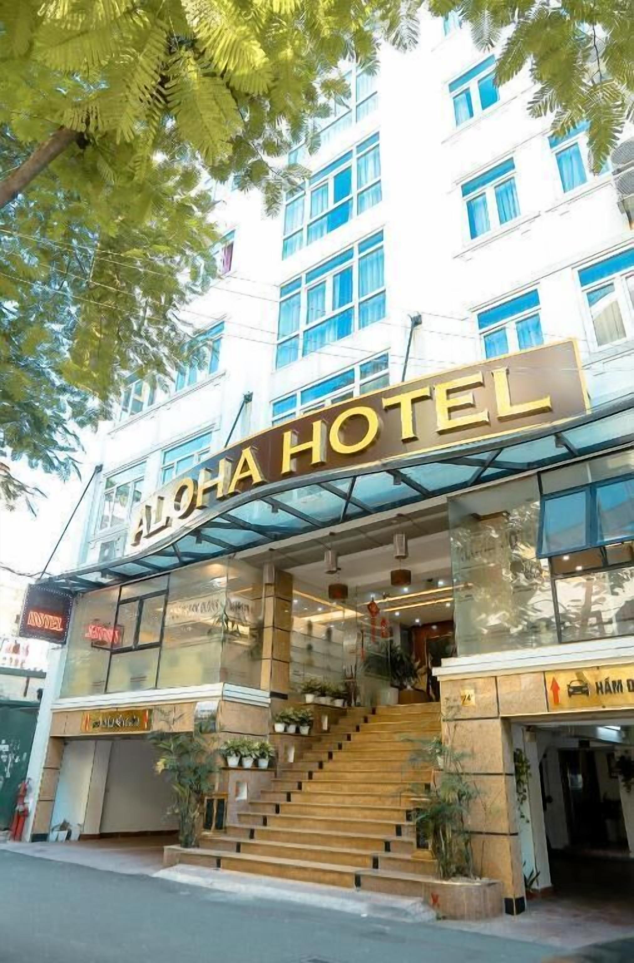 A hotel entrance with a sign reading "ALOHA HOTEL".