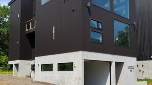 A modern two-story building with large windows and a flat roof. - Off Piste Chalet (Kutchan)