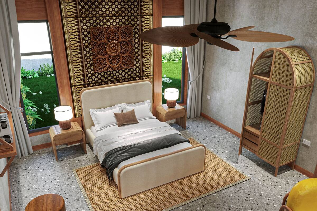 A bedroom with a bed, nightstands, a ceiling fan, a wardrobe, and a view of greenery outside.