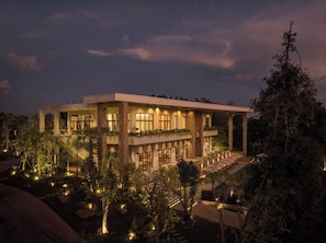 A modern two-story building with a balcony, surrounded by landscaped gardens and trees. - Samanea Wellness Resort (Veal Veaeng)