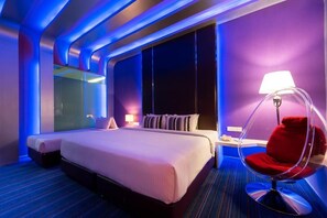A modern hotel room with a large bed, a red chair, and a large window. - Kingston Hotel 3 at Kuala Lumpur (Kuala Lumpur)