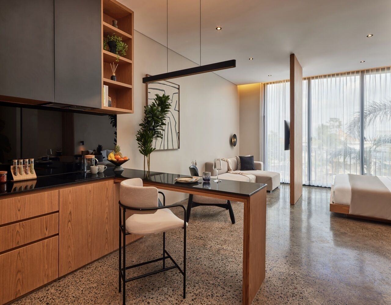 A modern living space with a kitchen, dining area, and seating area.