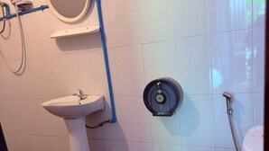 Un baño con lavamanos pedestal, inodoro y ducha.
