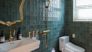 A bathroom with a pedestal sink, a toilet, a shower with a gold faucet, and a mirror with an ornate frame. - Ravenna. 5mis from Myeongdong/shopping/restaurant/beauty/skincare/suitefor10ppl (Seoul)