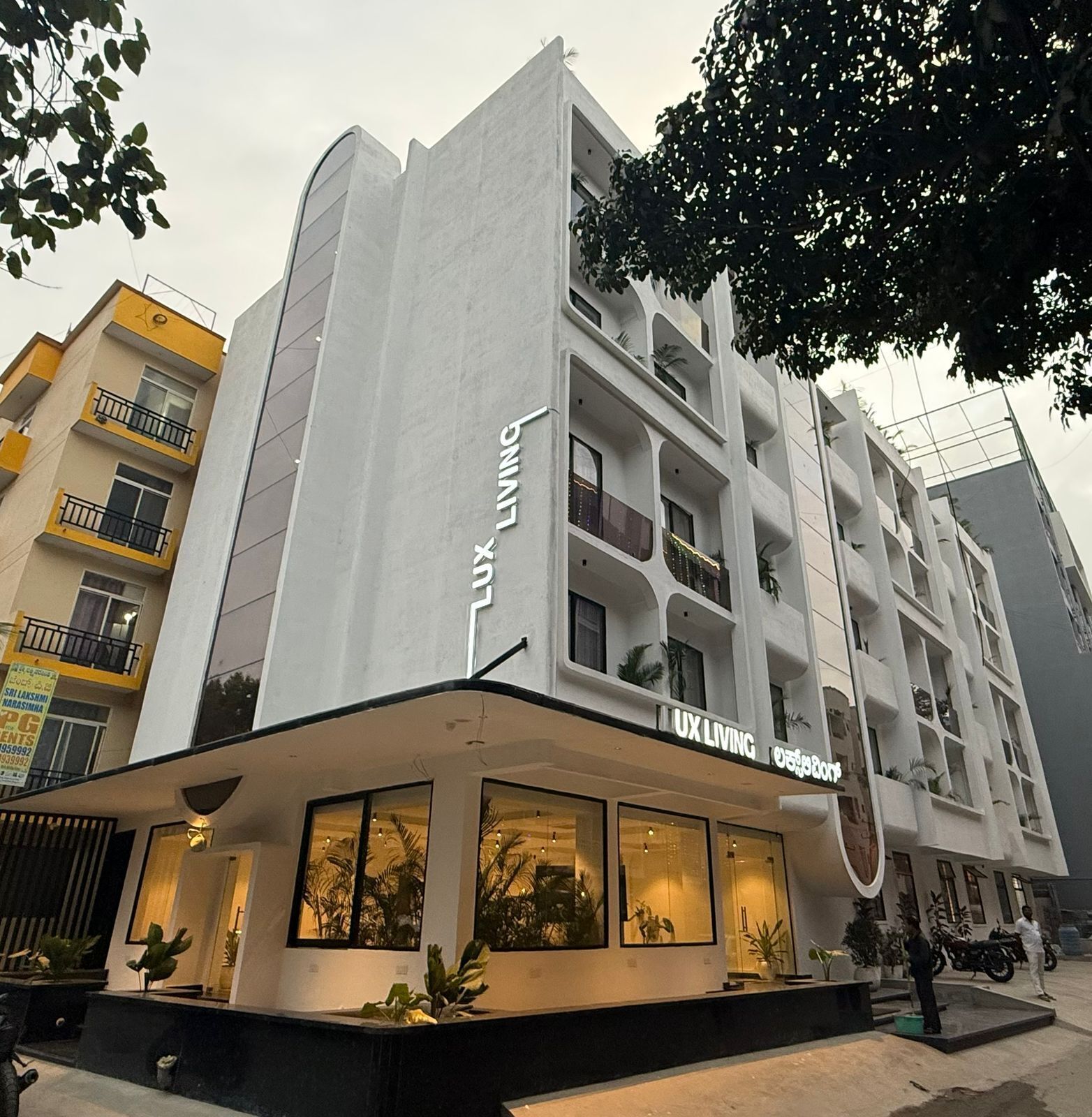 A modern building with a sign reading "UX LIVING".