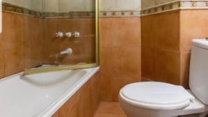 A bathroom with a glass-enclosed shower, a white bathtub, and a white toilet. - Blue hostel (Buenos Aires)