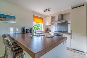 House | Private kitchen | Highchair - Charming Villa With Sauna on the Water (De Koog)