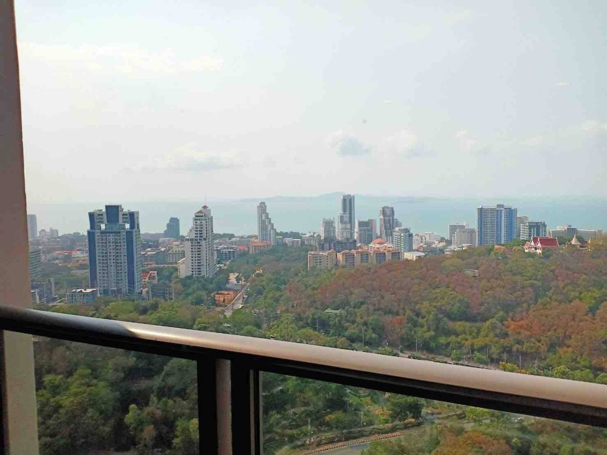 A cityscape with high-rise buildings and a view of the sea.