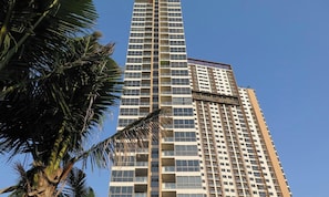 A tall, modern high-rise building with a grid of windows and balconies. - The Unixx South Pattaya (Pattaya)