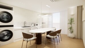 A modern kitchen with a central island, a sink, and a microwave.