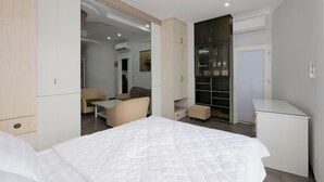 A modern bedroom with a bed, a desk, a chair, and a wardrobe. - The Elegant Comfort Corner in Central District 7, Ho Chi Minh City (P. Tan Phong, Q. 7)