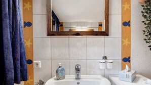 A bathroom with a sink, mirror, towel rack, and a bottle of hand soap. - Apartment 'Alte Schmiede 2 Apartments' with Mountain View, Private Terrace and Wi-Fi (Feldberg (Schwarzwald))