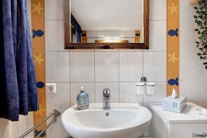 A bathroom with a sink, mirror, towel rack, and a bottle of hand soap. - Apartment 'Alte Schmiede 2 Apartments' with Mountain View, Private Terrace and Wi-Fi (Feldberg (Schwarzwald))