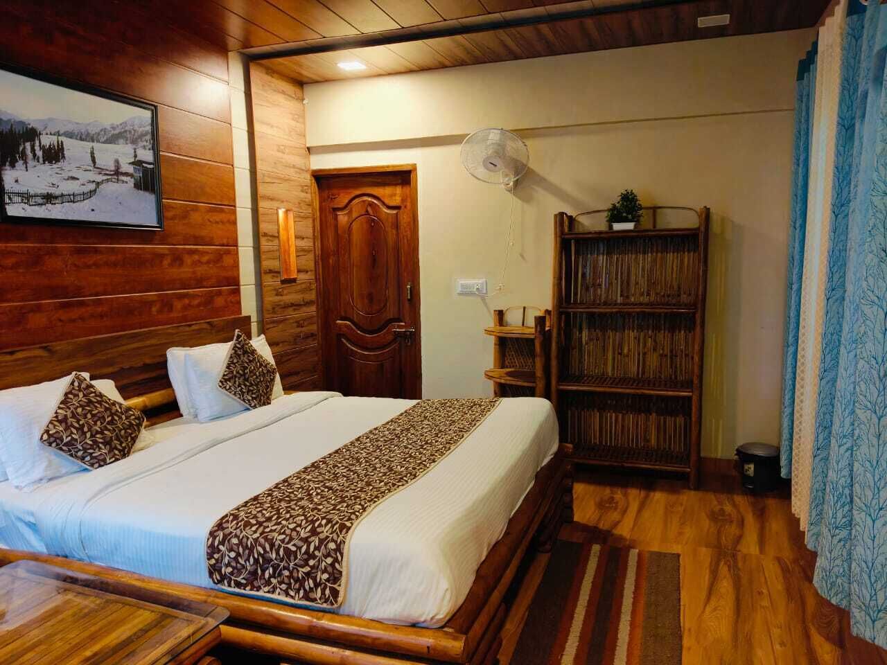 A room with a wooden bed, a bookshelf, and a door.