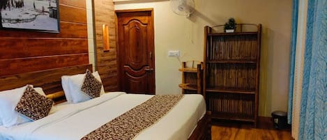 A room with a wooden bed, a bookshelf, and a door.