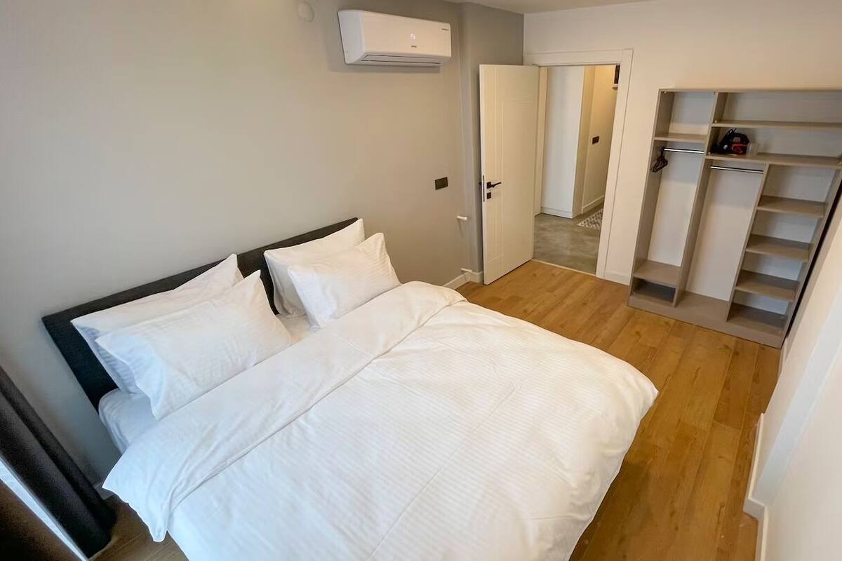 Una camera da letto con un letto, un armadio e una porta che dà su un'altra stanza.