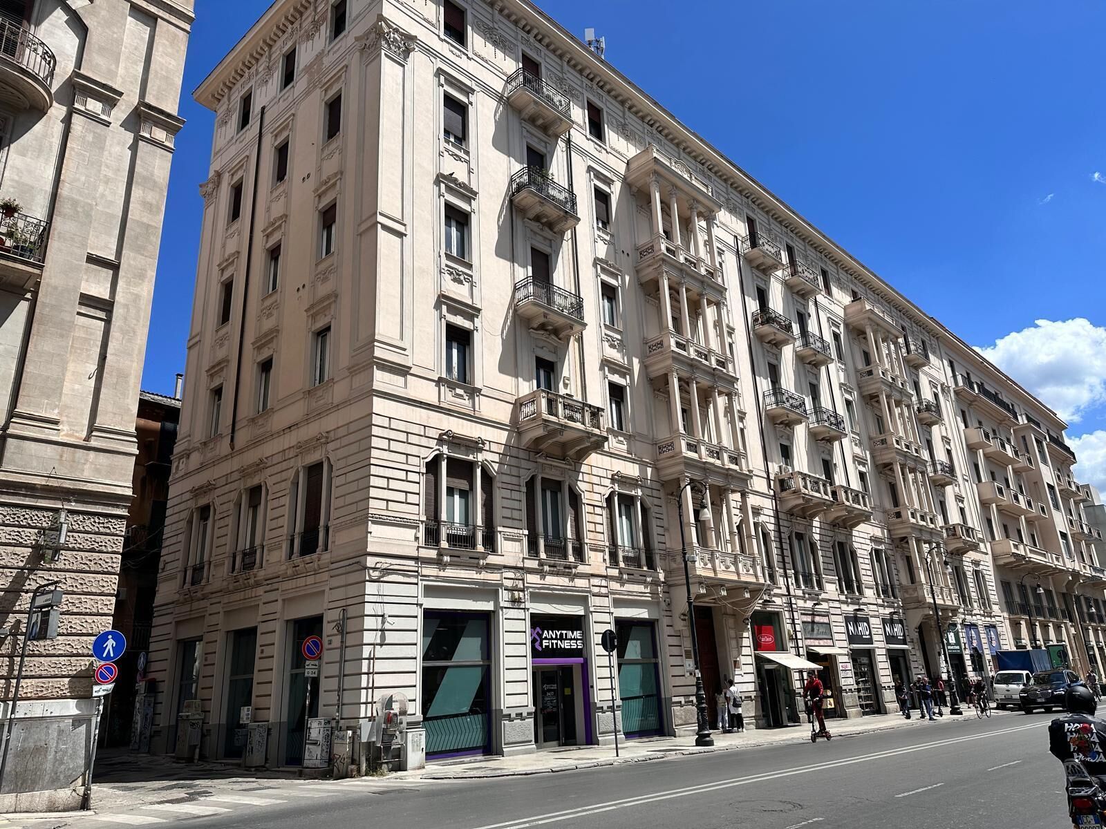 A multi-story building with a classical architectural style, featuring large windows and balconies.