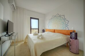 A hotel room with a bed, a TV, a bedside table, and a window. - 2 bedrooms, terrace, peaceful ocean view, 6-minute walk to the beach, A2B262 (Cannes)