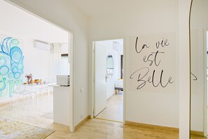 A modern interior with a kitchen area, a dining space, and a hallway leading to a bedroom. - 2 bedrooms, terrace, peaceful ocean view, 6-minute walk to the beach, A2B262 (Cannes)