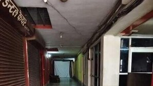 A corridor with closed shops on both sides, a tiled floor, and a red carpet at the entrance. - Hotel Rajshila (Prayagraj)