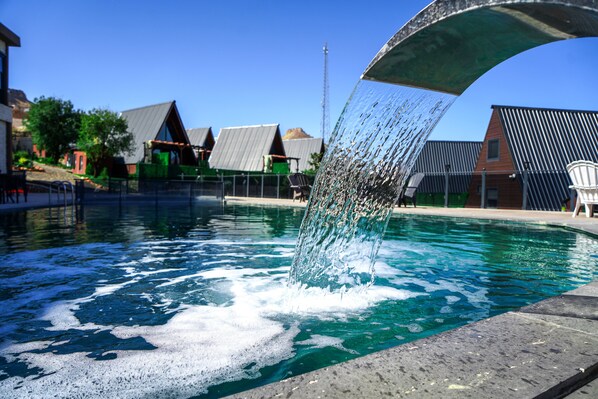 Seasonal outdoor pool, open noon to 6:00 PM, pool umbrellas