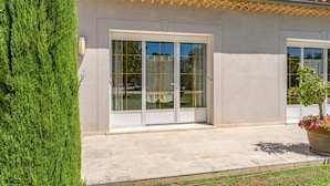 A building with a tiled roof, large glass doors, and a potted plant. - "Frédéric Mistral" Room at La Bastide des Mereuilles with Private Terrace, Wi-Fi & AC (Orange)